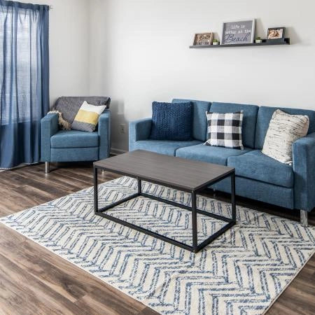 Blue fabric Austin sofa styled with throw pillows in a contemporary living room setting